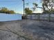 Photo shows an empty gravel-covered backyard with both wood and white vinyl fencing at 3615 Kingsbury Dr, Holiday, FL 34691
