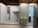 Unfinished basement features a utility sink and access to a bathroom at 3615 Kingsbury Dr, Holiday, FL 34691