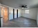 Bright bedroom with light gray flooring, neutral walls, ceiling fan, closet, and window at 3615 Kingsbury Dr, Holiday, FL 34691