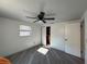 Bedroom with gray flooring, white walls, ceiling fan, and closet storage at 3615 Kingsbury Dr, Holiday, FL 34691