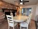 Dining room with a brick fireplace, ceiling fan, tile flooring, and sliding glass doors at 3615 Kingsbury Dr, Holiday, FL 34691