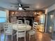 Dining room featuring a brick fireplace, ceiling fan, display case and a white dining set at 3615 Kingsbury Dr, Holiday, FL 34691