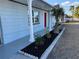 Well maintained blue home with mature palm trees and landscaping at 3615 Kingsbury Dr, Holiday, FL 34691