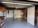 Spacious garage featuring ample storage, a utility sink, and a durable painted floor at 3615 Kingsbury Dr, Holiday, FL 34691