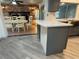 Kitchen island with granite countertops overlooks dining area and brick fireplace at 3615 Kingsbury Dr, Holiday, FL 34691