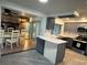 Bright kitchen and dining area features updated gray cabinets and stainless steel appliances at 3615 Kingsbury Dr, Holiday, FL 34691