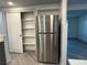 Stainless steel refrigerator with nearby pantry storage at 3615 Kingsbury Dr, Holiday, FL 34691