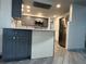 Bright kitchen with gray cabinets, stainless steel appliances, and ample counter space at 3615 Kingsbury Dr, Holiday, FL 34691