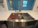Beautiful stainless steel kitchen sink, updated faucet, white countertop and a sunlit window with a view at 3615 Kingsbury Dr, Holiday, FL 34691