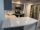 Modern kitchen boasts stainless steel appliances, gray cabinets, and quartz countertops at 3615 Kingsbury Dr, Holiday, FL 34691