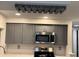 Kitchen features gray cabinets, stainless steel appliances, and a unique wine rack above the cabinets at 3615 Kingsbury Dr, Holiday, FL 34691