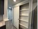 Spacious pantry with sliding door and ample shelving for organized storage at 3615 Kingsbury Dr, Holiday, FL 34691