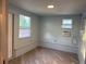 Room with updated gray tone walls and flooring, plus two windows allowing for bright natural light at 3615 Kingsbury Dr, Holiday, FL 34691