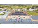 Aerial view of community center with parking, solar panels, and pristine landscaping at 37510 New Horizons Blvd, Zephyrhills, FL 33541