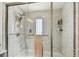 This bathroom showcases a frameless shower, a sleek showerhead, and a small window at 37510 New Horizons Blvd, Zephyrhills, FL 33541