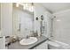 Clean bathroom with a vanity, a shower-tub combo, and bright overhead lighting at 37510 New Horizons Blvd, Zephyrhills, FL 33541