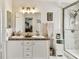 Bathroom features a double sink vanity with marble countertops and a glass-enclosed shower with marble tiling at 37510 New Horizons Blvd, Zephyrhills, FL 33541