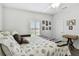 Bright bedroom with natural light and neutral color, featuring a decorative quilt and wall decor at 37510 New Horizons Blvd, Zephyrhills, FL 33541