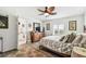 Light-filled bedroom with plantation shutters, wood flooring, and ensuite bathroom access at 37510 New Horizons Blvd, Zephyrhills, FL 33541