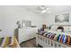 Bright bedroom showcasing a white dresser, coordinated bedding, and hardwood floors at 37510 New Horizons Blvd, Zephyrhills, FL 33541