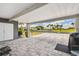 Spacious carport with decorative pavers offers an extended area for parking at 37510 New Horizons Blvd, Zephyrhills, FL 33541