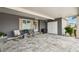 Spacious carport with decorative pavers, updated exterior paint, and a welcoming entryway at 37510 New Horizons Blvd, Zephyrhills, FL 33541