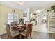 Dining room features a round table with cushioned chairs, and windows with blind-style shades at 37510 New Horizons Blvd, Zephyrhills, FL 33541