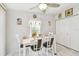 Bright dining room with a white table, chairs, modern decor, and lots of natural light at 37510 New Horizons Blvd, Zephyrhills, FL 33541