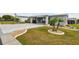 Charming home with lush lawn, mature trees, and stone-lined flower beds at 37510 New Horizons Blvd, Zephyrhills, FL 33541