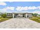 Inviting home with a paved driveway, covered entrance, and well-maintained landscaping at 37510 New Horizons Blvd, Zephyrhills, FL 33541