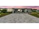 Charming single-story home with gray siding, manicured landscaping, and an extended paved driveway at 37510 New Horizons Blvd, Zephyrhills, FL 33541
