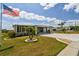 Charming home with well-manicured lawn and a long paved driveway at 37510 New Horizons Blvd, Zephyrhills, FL 33541