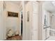 Bright hallway featuring hardwood floors, white cabinetry, and adjacent bathroom at 37510 New Horizons Blvd, Zephyrhills, FL 33541