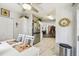 Open kitchen and dining area with stainless steel appliances, white cabinetry, and modern flooring at 37510 New Horizons Blvd, Zephyrhills, FL 33541