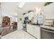 White kitchen features modern stainless steel appliances, stylish counters, and tile flooring at 37510 New Horizons Blvd, Zephyrhills, FL 33541