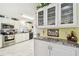 Bright, white kitchen featuring stainless steel appliances, white cabinets, and marbled countertops at 37510 New Horizons Blvd, Zephyrhills, FL 33541