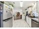 Bright kitchen features stainless steel appliances, modern counters, and beautiful tile flooring at 37510 New Horizons Blvd, Zephyrhills, FL 33541