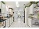 White kitchen features modern appliances, stylish counters, and beautiful tile flooring at 37510 New Horizons Blvd, Zephyrhills, FL 33541