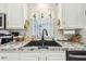 Close-up of the kitchen sink with modern fixtures, ample counter space, and bright lighting at 37510 New Horizons Blvd, Zephyrhills, FL 33541