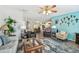 Comfortable living room featuring neutral-toned furniture, a decorative rug, and bright accent walls at 37510 New Horizons Blvd, Zephyrhills, FL 33541