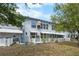 Backyard view of the condo featuring a white picket fence and well-maintained landscaping at 4151 55Th N Way # 1056, Kenneth City, FL 33709