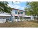 Backyard view of the condo featuring a white picket fence and well-maintained landscaping at 4151 55Th N Way # 1056, Kenneth City, FL 33709