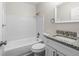 Bathroom featuring tub and shower combo, granite countertop, modern faucet, and tile flooring at 4151 55Th N Way # 1056, Kenneth City, FL 33709