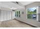 Bright bedroom features wood floors, ceiling fan, and large windows offering natural light and green views at 4151 55Th N Way # 1056, Kenneth City, FL 33709
