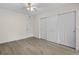 Neutral bedroom with wood floors, ceiling fan, closet space, and white trim and walls at 4151 55Th N Way # 1056, Kenneth City, FL 33709