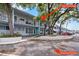Condo building exterior showcasing mature trees, reserved parking, and well-maintained grounds at 4151 55Th N Way # 1056, Kenneth City, FL 33709