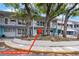 Charming exterior of the condo building with mature trees and landscaping at 4151 55Th N Way # 1056, Kenneth City, FL 33709