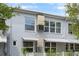 Exterior of the condo building, showcasing the building's facade, windows, and AC unit at 4151 55Th N Way # 1056, Kenneth City, FL 33709