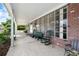 Covered front porch with brick accents, ample seating, and neighborhood views at 4151 55Th N Way # 1056, Kenneth City, FL 33709