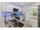 Bright kitchen with stainless appliances, granite counters and blue LED lighting at 4151 55Th N Way # 1056, Kenneth City, FL 33709